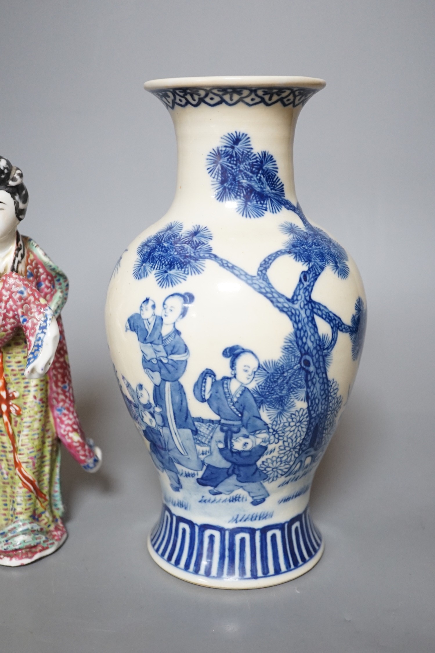 A Chinese blue and white figural vase and two polychrome figures, tallest 24cm